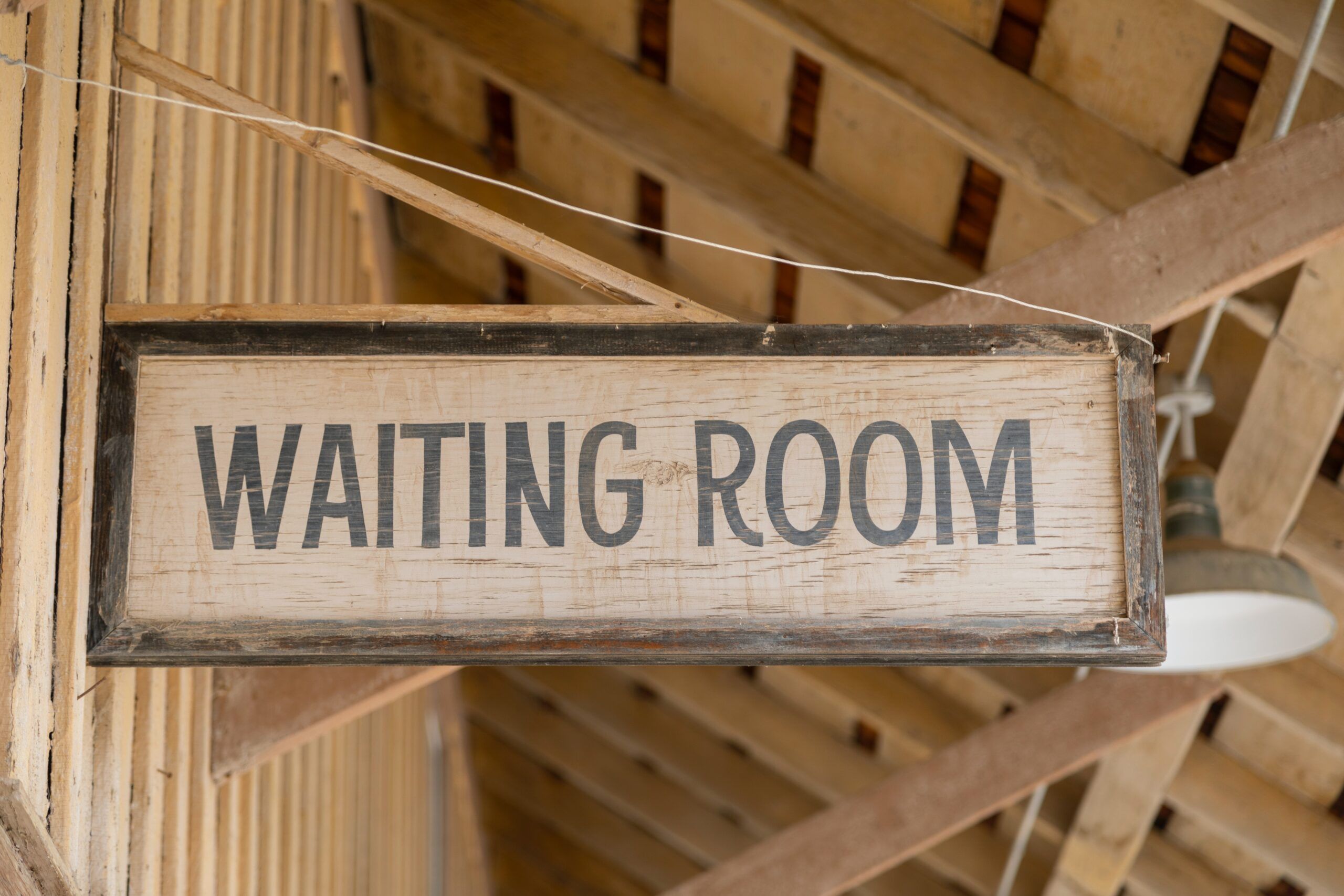 Waiting room sign in a wooden building