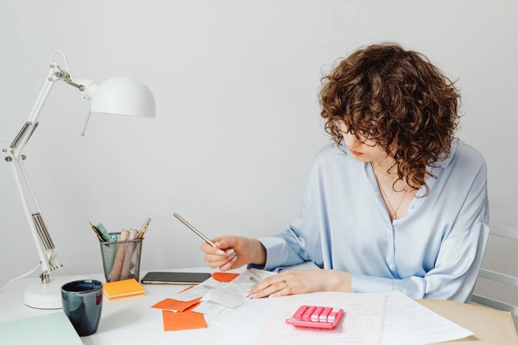 Woman preparing receipts for surrogate compensation payment