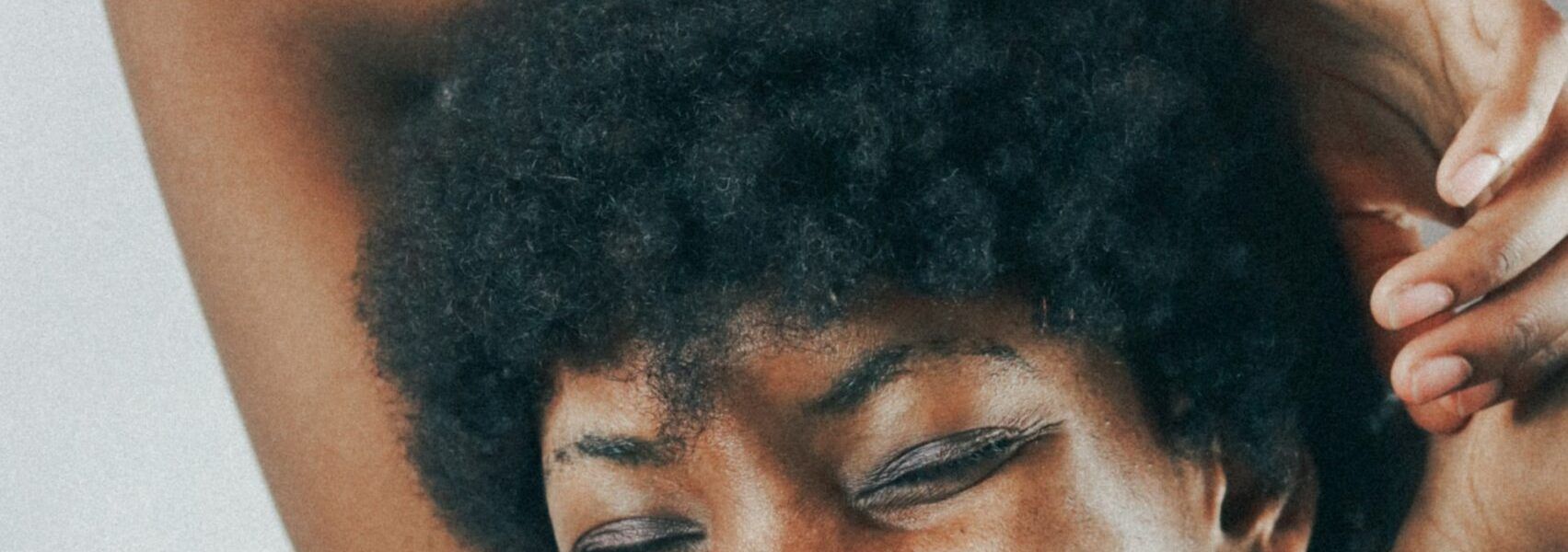 Black woman smiling because she got rid of fibroids