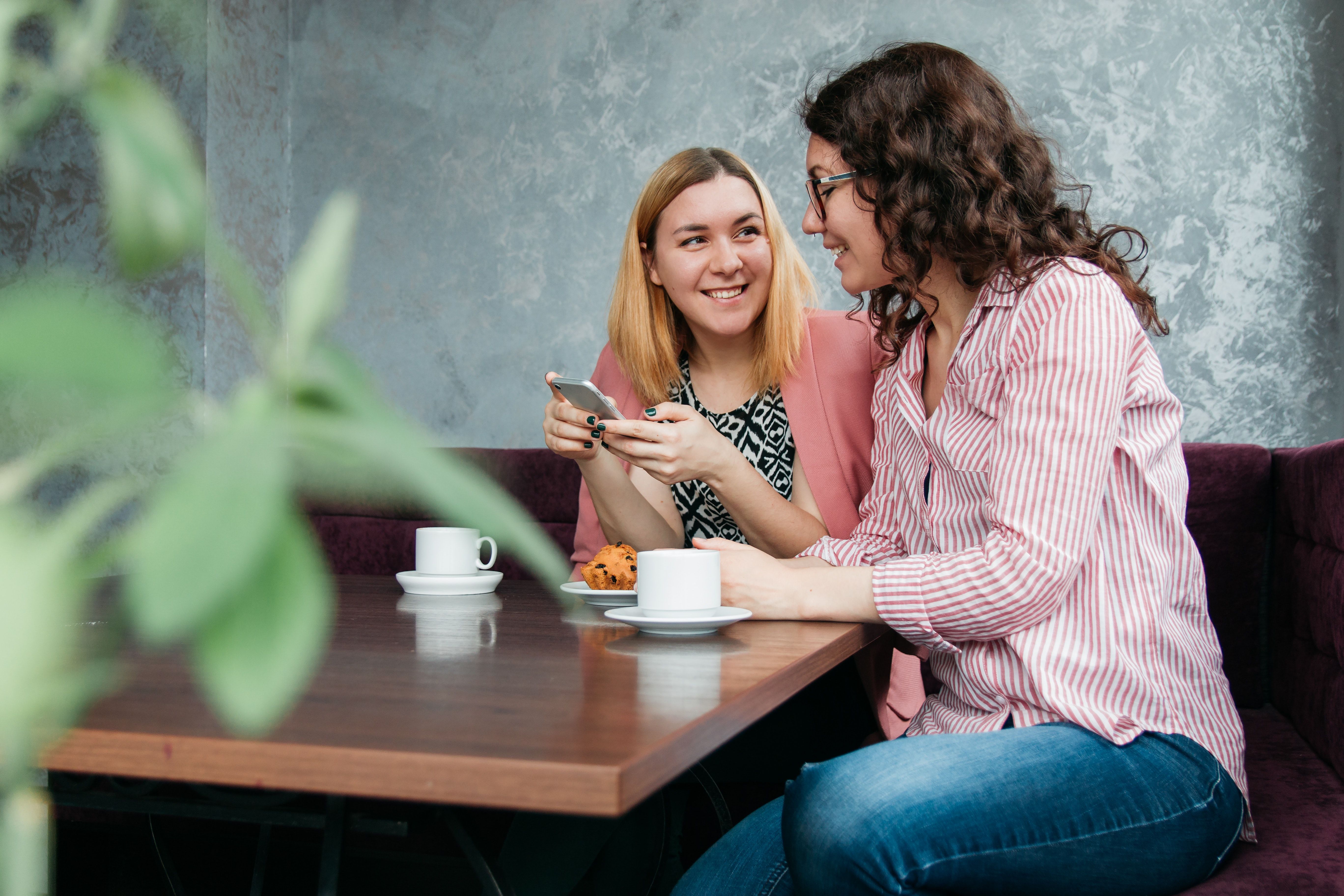 Two women sitting in a coffee shop talking