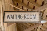Waiting room sign in a wooden building