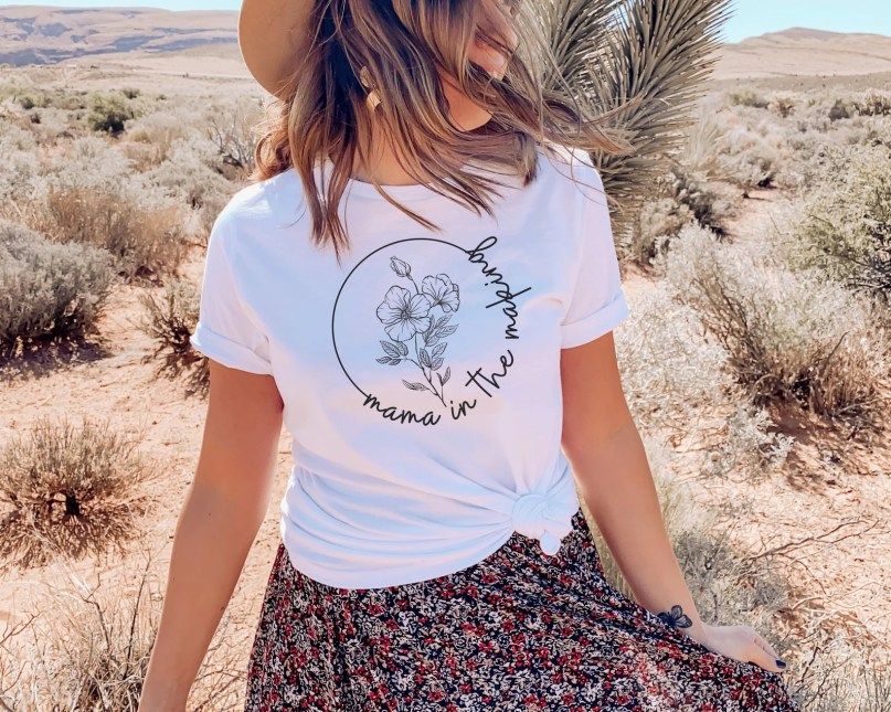 Woman wearing white Mama in the Making surrogacy shirt