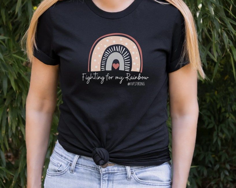 Woman wearing a fighting for my rainbow surrogacy shirt