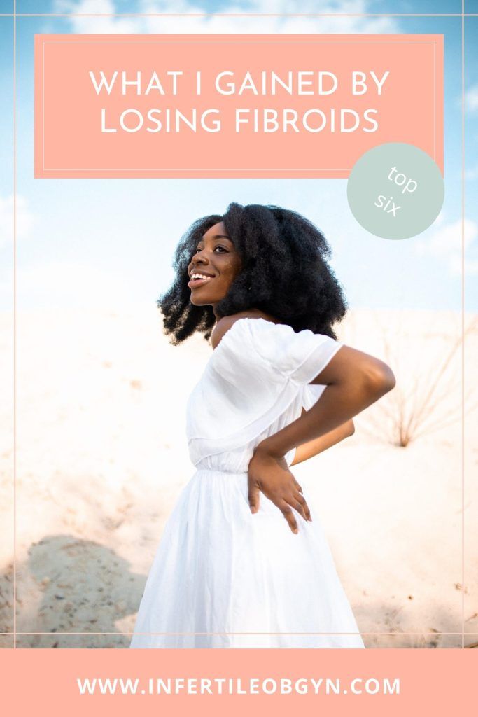 Woman smiling in white dress after getting rid of fibroids