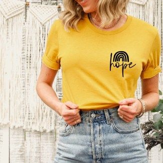 Woman wearing deep yellow greater the storm the brighter the rainbow surrogacy shirt